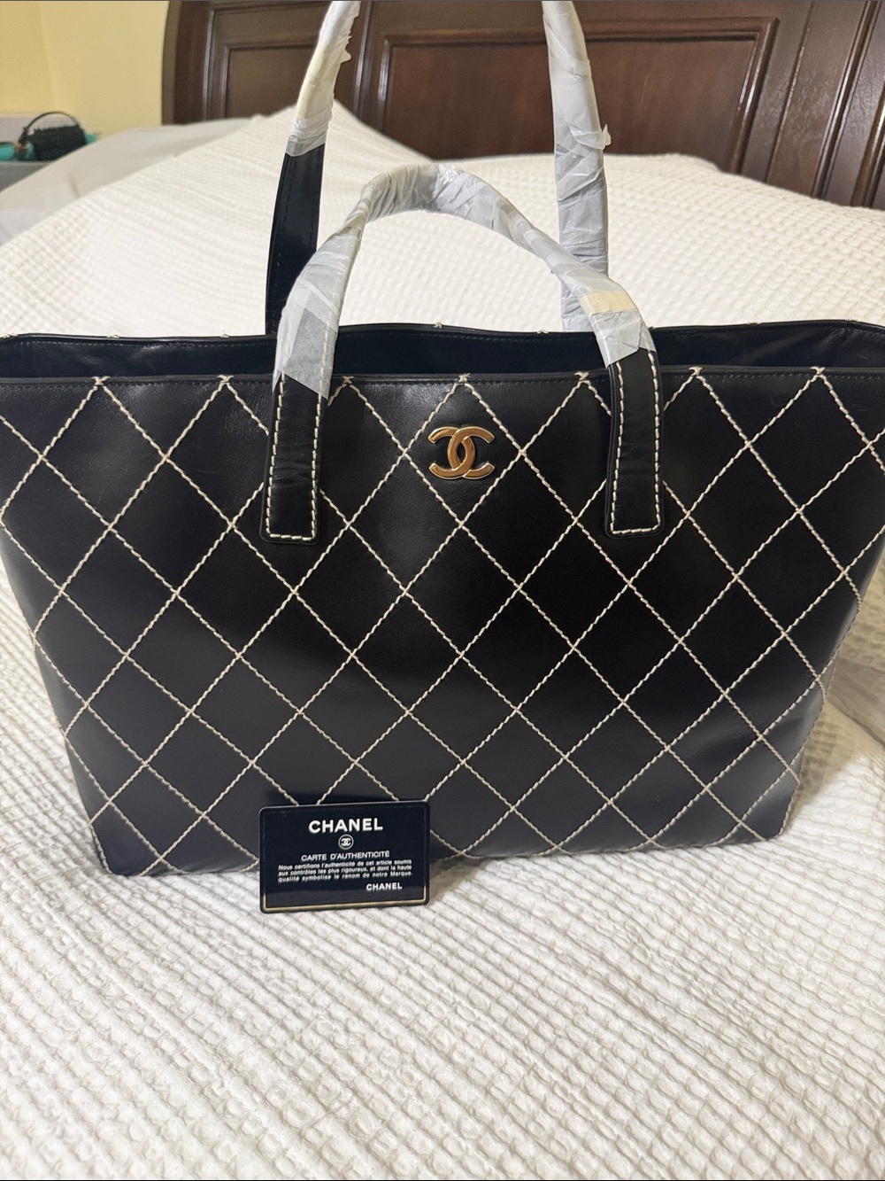CHANEL Black Quilted Tote with Gold CC Emblem and White Contrast Stitching